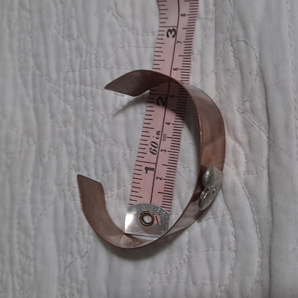 Copper cuff bracelet with heart on it